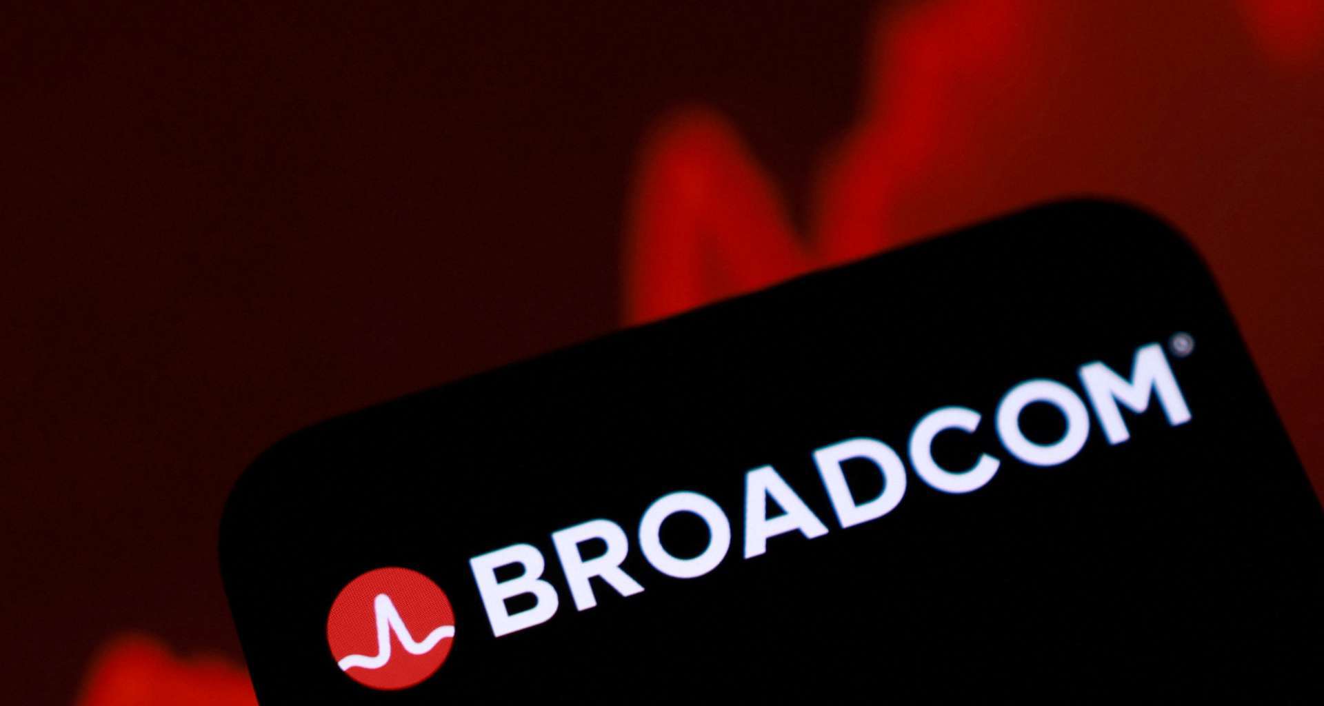 手機螢幕顯示博通Broadcom品牌標誌，背景為紅色走勢圖。